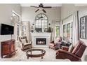 Bright living room with fireplace, large windows, and hardwood floors at 185 Players Club Dr, Castle Rock, CO 80104