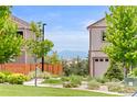 Charming home exterior with lush green landscaping, trees, and mountain views at 11684 Park South Loop, Parker, CO 80138