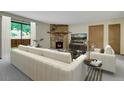 Comfortable living room with stone fireplace and ample natural light at 3335 S Ammons St # 6-105, Lakewood, CO 80227