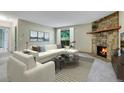 Inviting living room with a stone fireplace and plush seating at 3335 S Ammons St # 6-105, Lakewood, CO 80227