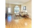 Cozy living room with hardwood floors, a large arched window, and a comfortable seating arrangement at 2414 S Gray Dr, Lakewood, CO 80227