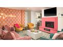Bright living room with decorative fireplace and cozy velvet seating at 7039 Otis Ct, Arvada, CO 80003