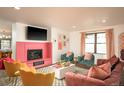Bright living room with decorative fireplace and cozy velvet seating at 7039 Otis Ct, Arvada, CO 80003
