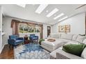 Bright living room featuring skylights, hardwood floors, and stylish decor at 6995 S Kendall Blvd, Littleton, CO 80128