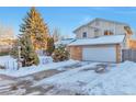 Two-story house with attached garage and snow-covered front yard at 2325 15Th Ave, Longmont, CO 80503