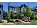 Stylish two-story home with a covered porch, stone accents, and a well-manicured front yard at 1362 Golden Eagle Way, Louisville, CO 80027