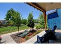 Inviting front porch with cozy seating and lush landscaping, perfect for relaxing at 1362 Golden Eagle Way, Louisville, CO 80027
