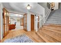 Inviting foyer with hardwood floors, staircase, and an adjacent office space at 7030 S Fillmore Ct, Centennial, CO 80122