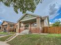 Charming brick bungalow featuring a covered porch and well-maintained front yard at 1615 Osceola St, Denver, CO 80204