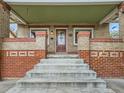 Welcoming brick front porch with decorative columns and vintage details at 1615 Osceola St, Denver, CO 80204