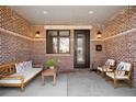 Cozy patio with comfortable seating, decorative accents, and charming brick walls at 1688 S Grant St, Denver, CO 80210