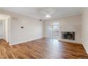 Bright living room featuring wood floors, a fireplace, and sliding doors to the balcony at 7665 E Eastman Ave # 302B, Denver, CO 80231
