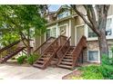 Inviting townhome exterior featuring twin staircases, neutral paint, and verdant landscaping at 1885 S Quebec Way # G 106, Denver, CO 80231