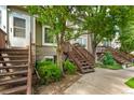 Townhome exterior showing entryways, staircases, and well-maintained landscaping at 1885 S Quebec Way # G 106, Denver, CO 80231
