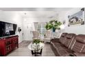 Bright living room with updated flooring, neutral walls, and comfortable seating at 1885 S Quebec Way # G 106, Denver, CO 80231