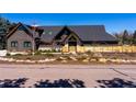 Stunning home exterior with modern design, complemented by mature landscaping and fence at 5859 E Ida Pl, Greenwood Village, CO 80111