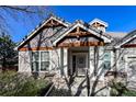Detailed view of the front entrance with decorative columns, ironwork door, and stone accents at 1430 Bluefield Ave, Longmont, CO 80504
