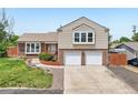 Charming two-story home features a two-car garage, brick accents, and well-maintained landscaping at 1973 Bahama St, Aurora, CO 80011