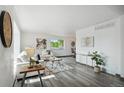 Bright living room boasts large windows, neutral decor, and wood laminate flooring at 1973 Bahama St, Aurora, CO 80011