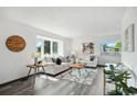 Bright living room boasts large windows, neutral decor, and wood laminate flooring at 1973 Bahama St, Aurora, CO 80011