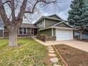 Charming two-story home featuring an attached two car garage and manicured lawn and garden at 6640 S Heritage W Pl, Centennial, CO 80111