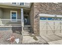 Close up of the home's entrance, showing steps to the front door and a partial view of the garage at 17632 Datura St, Broomfield, CO 80023