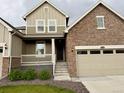Inviting front exterior showing a charming porch, two-car garage, and meticulously kept landscaped grounds at 17632 Datura St, Broomfield, CO 80023