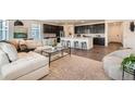 Stylish living room with an open floor plan, flows to the kitchen, with sleek countertops and bar stool seating at 17632 Datura St, Broomfield, CO 80023