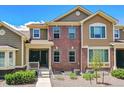 Two-story townhome featuring brick and siding exterior with well-maintained landscaping at 6284 Orion Ct # B, Arvada, CO 80403