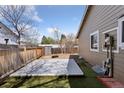 The backyard features a wooden fence, a small deck, and a low-maintenance yard at 15427 E Oberlin Pl, Aurora, CO 80013