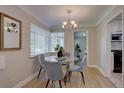 Cozy dining room with a glass table, chandelier, and natural light from the corner windows at 2812 Krameria St, Denver, CO 80207