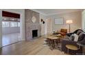 Inviting living room with hardwood floors, brick fireplace, and neutral paint colors at 2812 Krameria St, Denver, CO 80207
