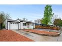 Inviting single-story home with a lush landscaped front yard and a driveway leading to the attached garage at 7841 Oneida St, Commerce City, CO 80022