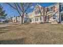 Street view showcasing a row of colorful townhomes with manicured front lawns at 9473 W Ontario Dr, Littleton, CO 80128