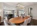 Open dining space with modern lighting fixture and view of the kitchen at 11008 Hayloft St, Parker, CO 80134