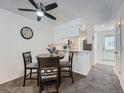 Cozy dining area with a round table and a view of the modern kitchen at 14222 E Hawaii Cir # F, Aurora, CO 80012