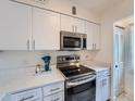 Bright kitchen with stainless steel appliances, white cabinets, and Quartz countertops at 14222 E Hawaii Cir # F, Aurora, CO 80012