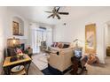 Bright living room with a ceiling fan, ample natural light and a cozy fireplace at 7440 S Blackhawk St # 4-105, Englewood, CO 80112