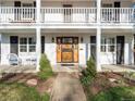 Close up of a beautiful front door, double porches, and manicured landscaping at 1100 Hudson St, Denver, CO 80220