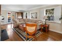 Cozy living room featuring hardwood floors, a sectional sofa, and ample natural light at 1100 Hudson St, Denver, CO 80220