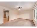 Spacious living area features carpeting, light walls, and a ceiling fan at 3780 E 117Th Ave, Thornton, CO 80233