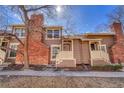 Charming two-story townhome with brick chimney, porch, and mature tree in front yard at 2062 S Helena St # B, Aurora, CO 80013