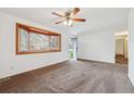 Bright living room with a bay window and neutral walls at 6609 W Mexico Pl, Lakewood, CO 80232