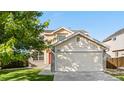 Charming home featuring a two-car garage and a well-manicured front yard at 18897 E Linvale Pl, Aurora, CO 80013