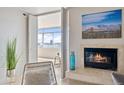 Living room showcases a fireplace, comfortable seating, and balcony doors with bright city views at 1313 N Williams St # 1103, Denver, CO 80218