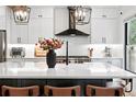 Modern kitchen boasts a large island, updated appliances, and stylish black accents at 3008 N York St, Denver, CO 80205