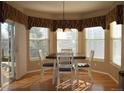 Eat-in breakfast nook with a wood table set, bright natural light, and pleasant outdoor views at 6368 S Walden Way, Aurora, CO 80016