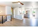 Bright and airy living room featuring sleek floors, modern railings and open concept layout with kitchen at 10932 W 107Th Ave, Broomfield, CO 80021