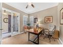 Inviting home office with natural light, neutral colors, and classic wooden desk at 6999 S Tempe Ct, Aurora, CO 80016