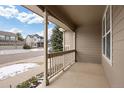 Inviting front porch with stylish railings and a view of the neighborhood at 7099 Cerney Cir, Castle Pines, CO 80108